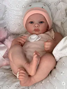 Close-up of Meadow reborn baby doll with realistic 3D skin texture and pink baby outfit