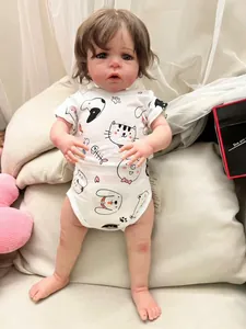 Detail of a 60cm lifelike reborn baby doll Sandie in a cat printed white romper outfit
