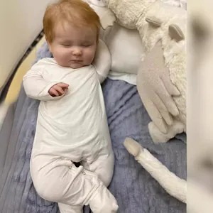 60cm realistic reborn baby doll Joseph in white long sleeve onesie sleeping on soft bedding