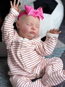 Close-up of 20-inch reborn doll featuring visible veins, 3D skin and striped pajamas