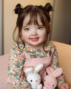 Close-up of lifelike 70cm reborn baby doll featuring floral shirt and pink overalls