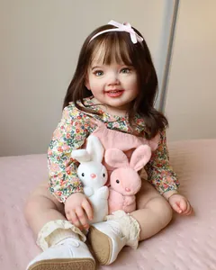 Detail of 70cm reborn doll Cammi with brown hair holding two plush bunny toys