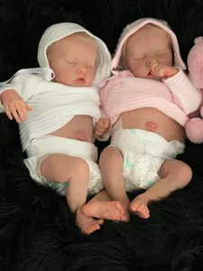 Detailed view of 48cm reborn baby dolls showing realistic skin texture and knit outfits