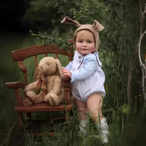55cm lifelike baby doll Zoe wearing a blue striped onesie and cute bunny ear hat