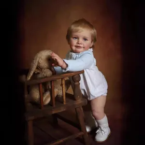 55cm realistic reborn baby doll Zoe with blue eyes and blue knitted cardigan