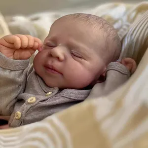 Close-up of 19 inch reborn doll showing realistic skin texture and sleepy face details