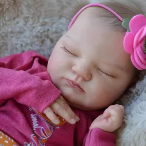 Lifelike 19-inch sleeping reborn baby doll with pink flower headband and soft cotton outfit