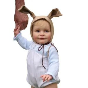 55cm lifelike reborn baby doll Zoe with blue eyes and long rabbit ear hat on white background