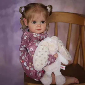 Lifelike toddler Maggi reborn doll in purple floral outfit holding a plush bunny toy