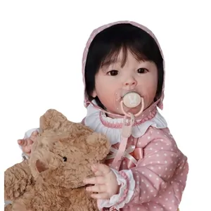 Realistische reborn babypop van 23 inch in roze polkadot-outfit met pluchen teddybeer