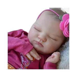 Realistic 19-inch reborn baby doll with closed eyes in pink outfit and flower headband