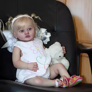 Realistic 60cm reborn baby doll with blonde curls, floral dress and a small teddy bear
