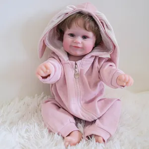 50cm realistic Reborn Doll Maddie in pink bunny hooded romper on plush rug