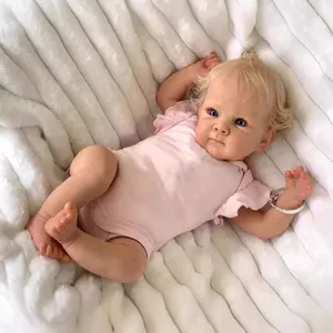 Realistic 18-inch reborn baby doll with blonde curls, blue eyes, and pink romper