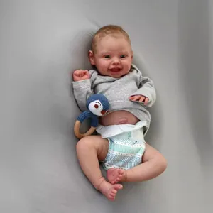 Realistic 50cm reborn baby doll in grey hoodie with crochet penguin toy and wooden ring