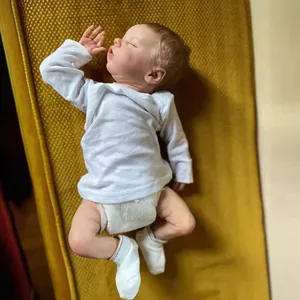 Realistic 18-inch reborn baby doll sleeping in white outfit with lifelike skin details