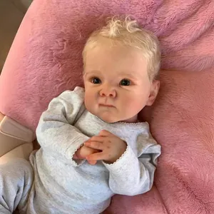 18-inch Bettie reborn baby doll with blonde curls and grey lace romper on pink plush