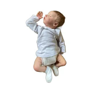 Realistic 18-inch sleeping reborn baby doll in white cotton outfit and diaper
