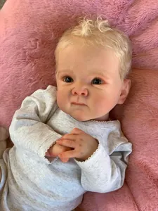 Close-up of 18-inch lifelike reborn baby doll with blonde hair and green eyes in grey outfit