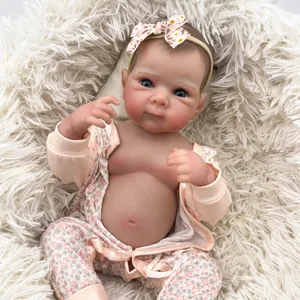 Realistic 18-inch reborn baby doll Bettie in pink floral outfit on white plush mat