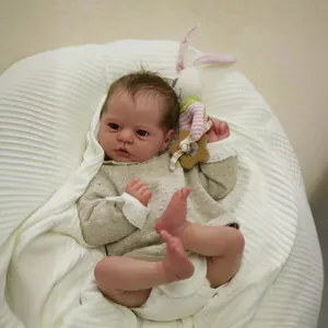 Realistic 19-inch reborn baby doll with visible veins wearing beige knit outfit