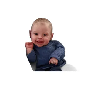Lifelike 50cm Harper reborn baby doll wearing a blue waffle knit sweater on white background
