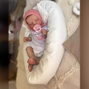 Lifelike 50cm Reborn baby doll in pink knit hat sleeping in white nest with pacifier