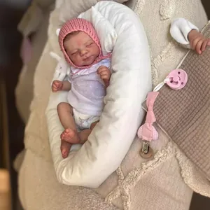 Realistic reborn doll detail showing detailed skin texture and pink knit hat
