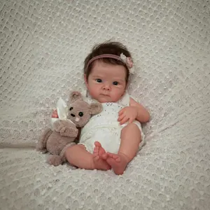 18-inch realistic reborn baby Bettie doll in white knit romper with crochet bear