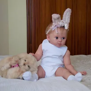 Detailed view of 24-inch realistic reborn baby doll with hand-painted hair and blue eyes