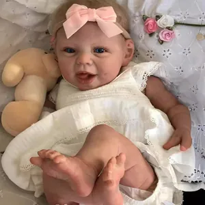 Close-up of lifelike 22-inch reborn doll with lace dress and pink velvet headband