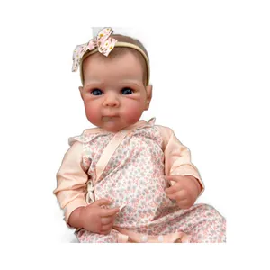 Realistic 18-inch newborn baby doll with blue eyes and floral outfit in sitting pose
