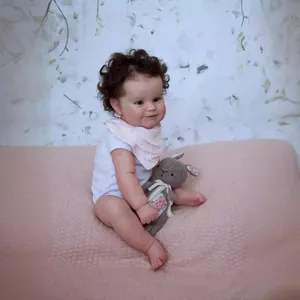 Lifelike 50cm reborn baby doll with curly hair, white bodysuit and bunny toy