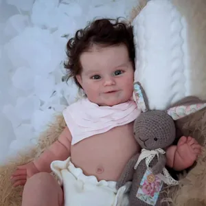 Close-up of lifelike Maddie doll with realistic skin texture and soft dark curls