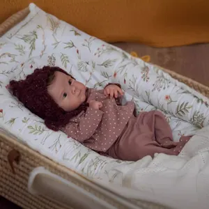 Realistic 18 inch reborn baby doll Bettie with knit hat and polka dot outfit in basket