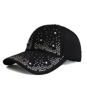 Detail view of black baseball cap with sparkling rhinestones and star-shaped metal studs