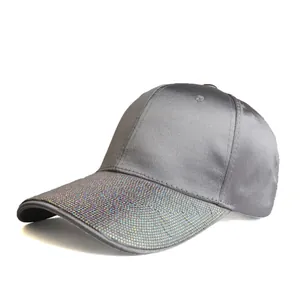Detail of shimmering iridescent rhinestones on a grey satin baseball cap visor
