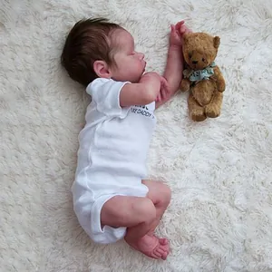 Realistic 18-inch reborn baby doll in white 'LIKE DADDY' romper on plush rug