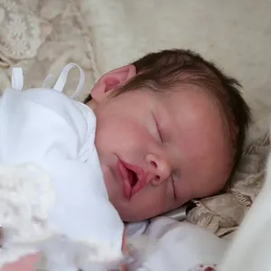 Close-up of lifelike 18 inch reborn baby doll with realistic skin texture and soft hair