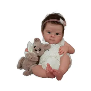 Lifelike 18-inch Bettie reborn baby doll in white knit romper with plush bear