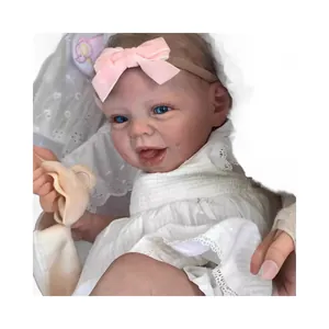 22-inch realistic reborn doll with blue eyes and pink bow in white lace dress