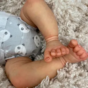 Detailed view of realistic 18 inch Reborn Baby Doll feet with lifelike skin and panda diaper