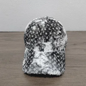 Distressed black and white washed baseball cap with silver sequins and frayed edges