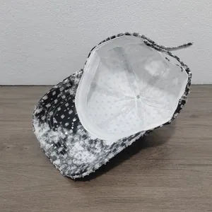 Internal detail of distressed denim baseball cap with sequins and adjustable strap