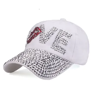 White cotton baseball cap with LOVE rhinestone embellishments and a sparkly studded brim
