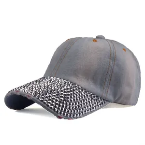 Detailed view of shimmering silver rhinestones on blue denim baseball cap brim