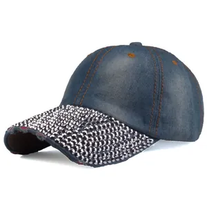 Close-up of sparkling rhinestones on denim baseball cap brim with distressed details