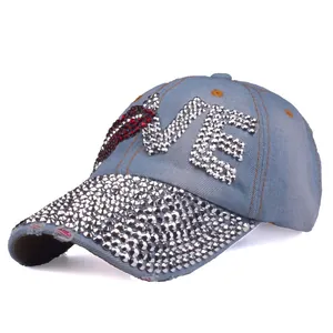 Detail view of denim baseball cap with LOVE rhinestone letters and silver cone studs
