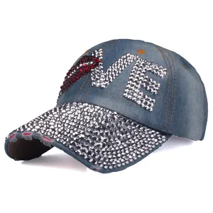 Close-up of distressed denim baseball cap with LOVE rhinestone design and sequin brim