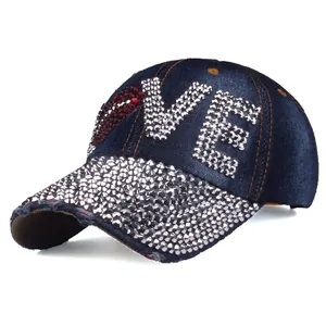 Detail of denim baseball cap with rhinestone LOVE lettering and silver cone studs